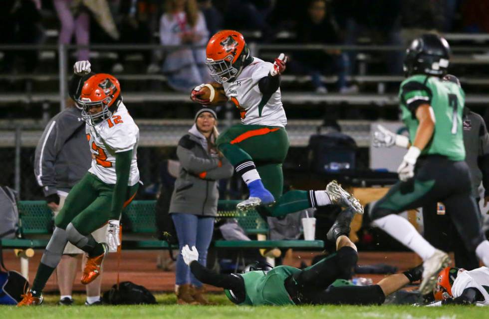 Mojave’s Tawee Walker (3) leaps over a Virgin Valley player during the Class 3A state ...