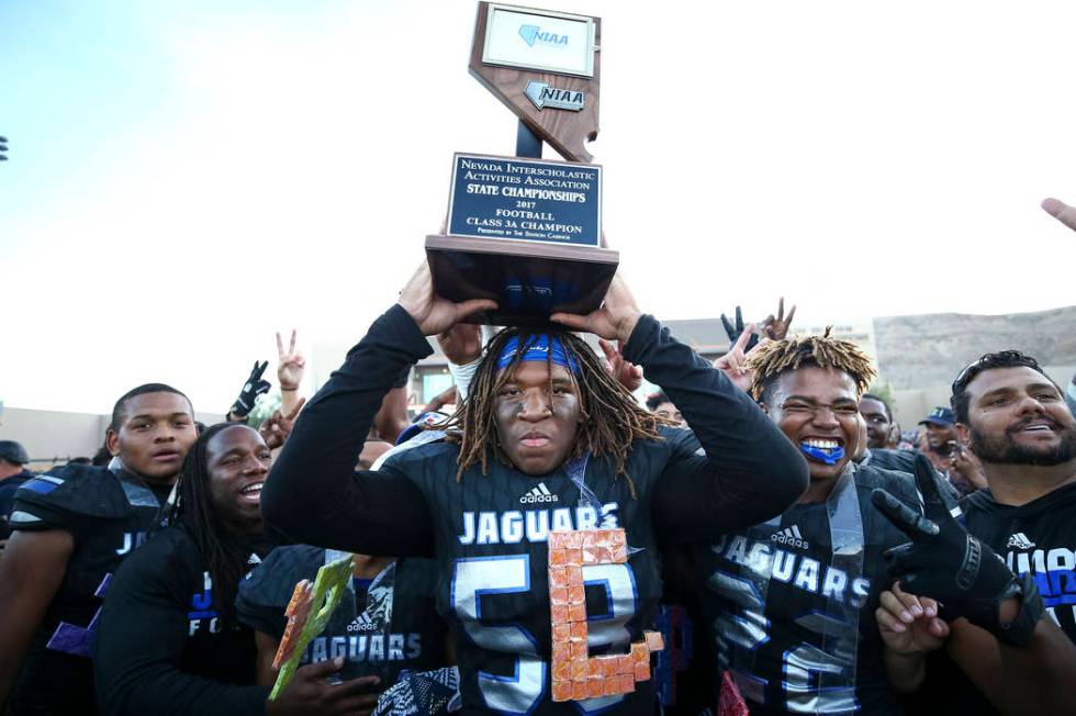 Desert Pines’ Lorenzo Sheldon Brown, center, and teammates celebrate their 54-24 victo ...