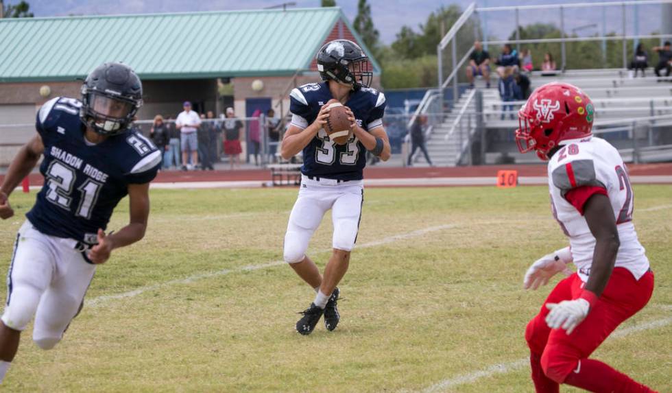 Shadow Ridge quarterback Kody Presser (33) looks for the open receiver against Arbor View du ...