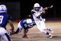 Foothill’s Koy Riggin (18), right, runs past Basic’s Julio Duron (65), center, d ...