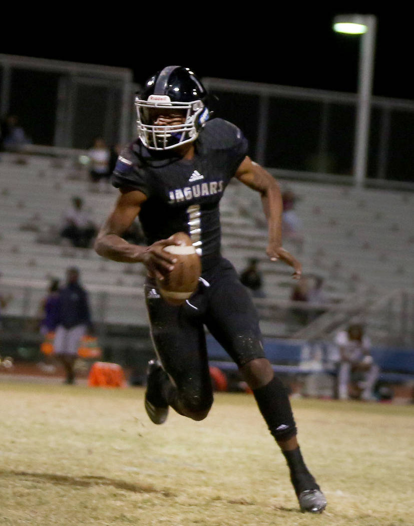 Desert Pines’ quarterback Tyler Williamson runs with the ball against Sunrise Mountain ...