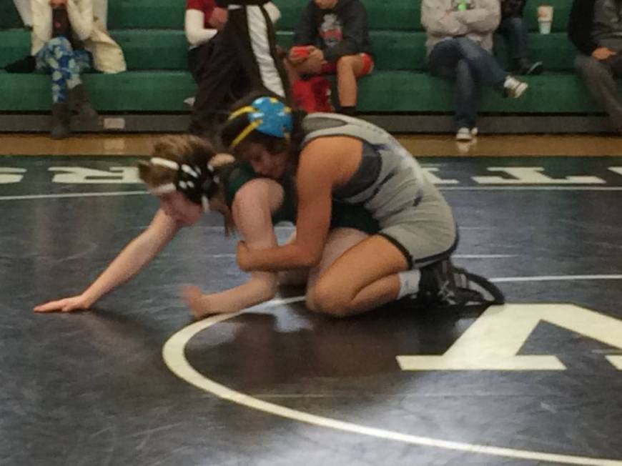 Tatum Pine, 15, of Palo Verde High School, presses one arm to the floor as she wrestles Teha ...