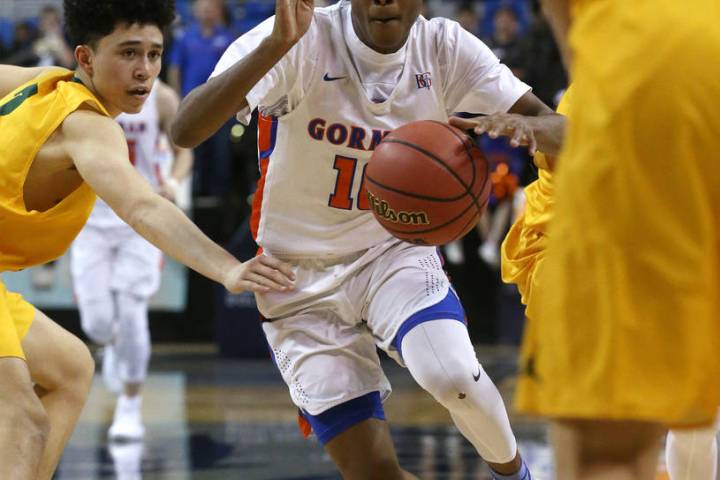 Bishop Gorman’s Zaon Collins drives past a Bishop Manogue defender during the 4A NIAA ...