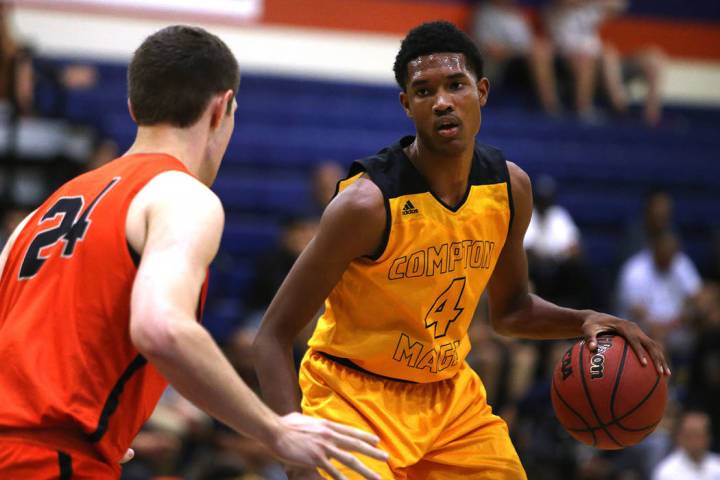 Compton Magic’s Evan Mobley (4) attempts to pass Bishop Gorman’s Myles Bendavid ...