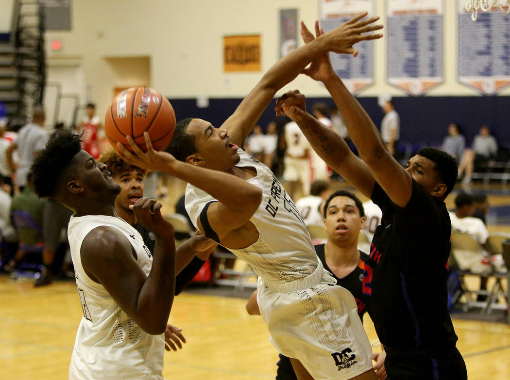 DC Premier’s Mekhi Long (11) throws a basket against The Truth’s Carl Lewis (32) ...