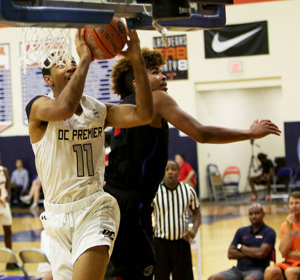 DC Premier’s Mekhi Long (11) jumps to shoot a basket past The Truth’s Kirk Smith ...