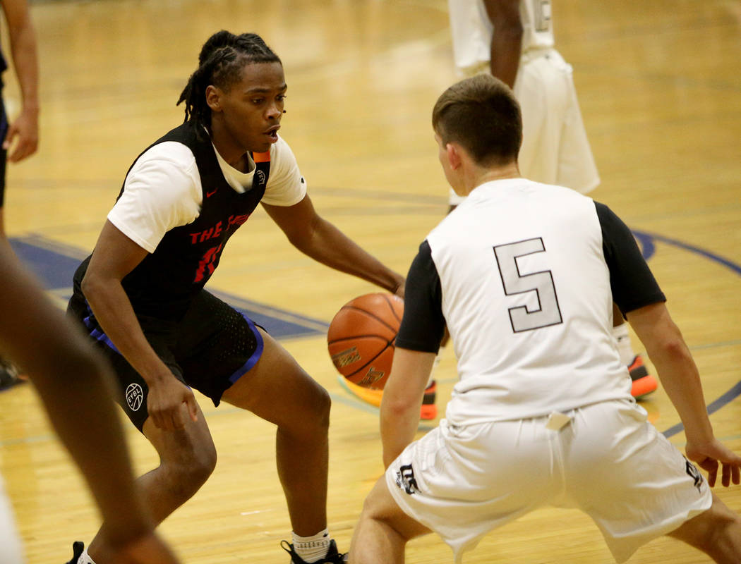 The Truth’s Earvin Knox (11) prepares to dribble past DC Premier’s Evan Buckley ...