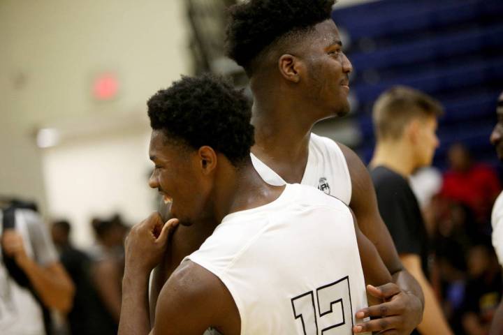 DC Premier’s Makhi Mitchell (15) hugs his teammate Joshua Wallace (12) after winning a ...