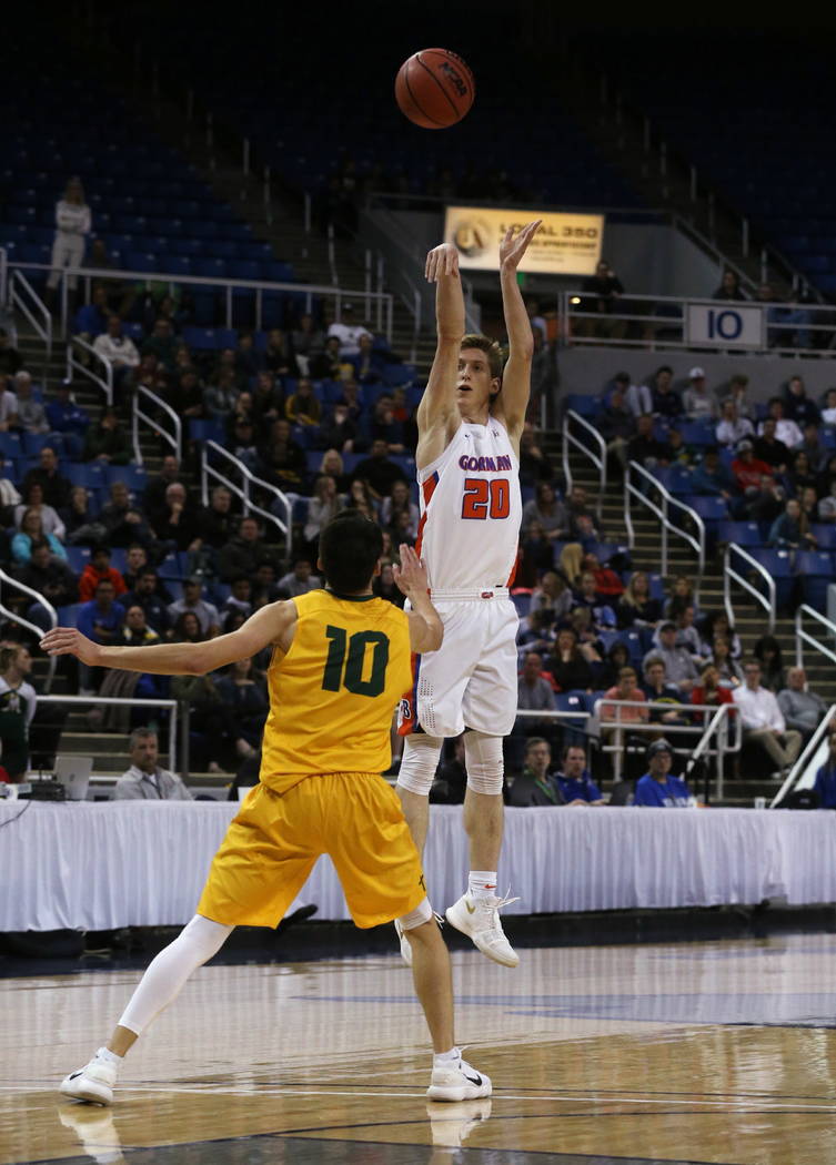 Bishop Gorman’s Noah Taitz shoots over Bishop Manogue defender Kolton Frugoli during t ...