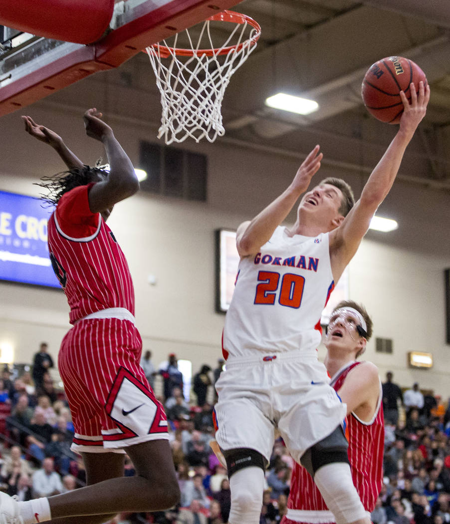 Bishop Gorman’s Noah Taitz (20) shoots while Findlay Prep’s Bol Bol (10) looks t ...