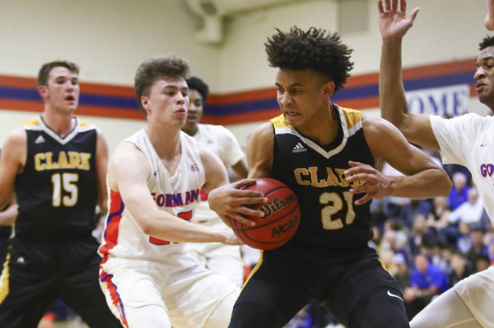 Clark’s Jalen Hill (21) drives against Bishop Gorman’s Chance Michels (25) durin ...