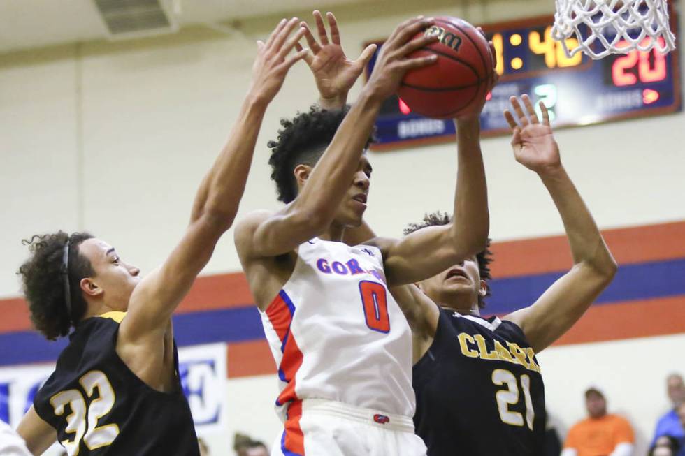 Bishop Gorman’s Isaiah Cottrell (0) gets a rebound over Clark’s Ian Alexander (3 ...