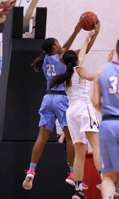 Centennial’s Daejah Phillips (23) grabs a rebound during the second half of a Class 4A ...