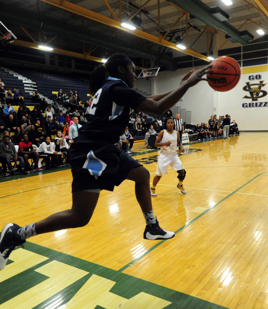 Centennial guard Eboni Walker tries to save a ball from going out of bounds against Spring V ...