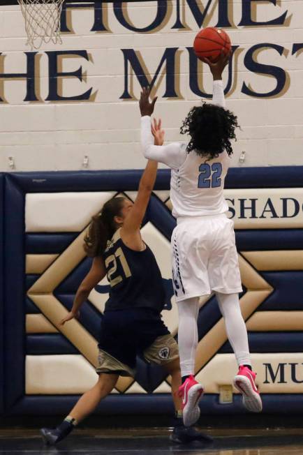 Centennial’s Eboni Walker (22) shoots over Spring Valley’s Ella Zanders (21) dur ...