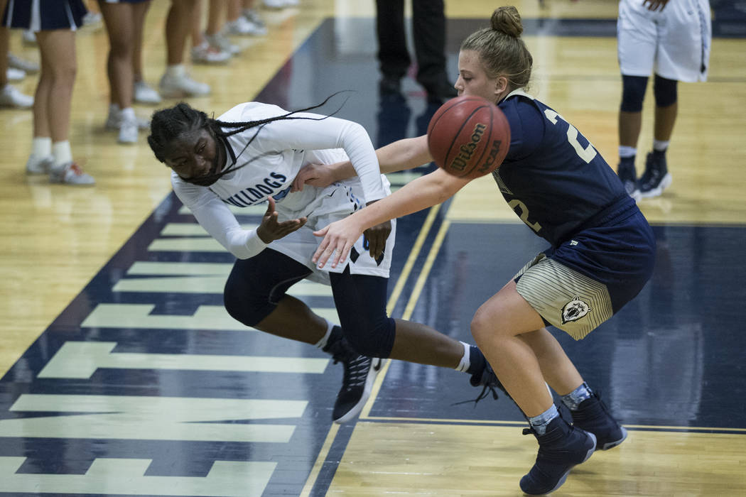 Centennial’s Eboni Walker (22) saves the ball against Spring Valley in the girls baske ...