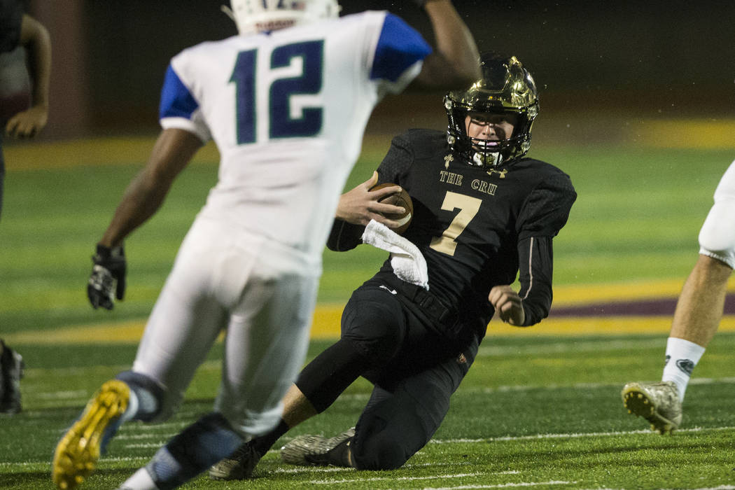 Faith Lutheran’s quarterback Sagan Gronauer (7) slides for a gain of yards against Gre ...