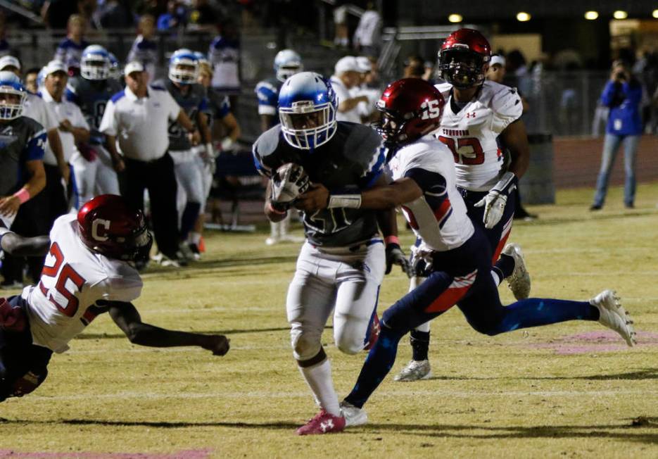 Coronado’s Ayzayah Hartfield (15) tackles Basic’s Dorian McAllister (21) during ...