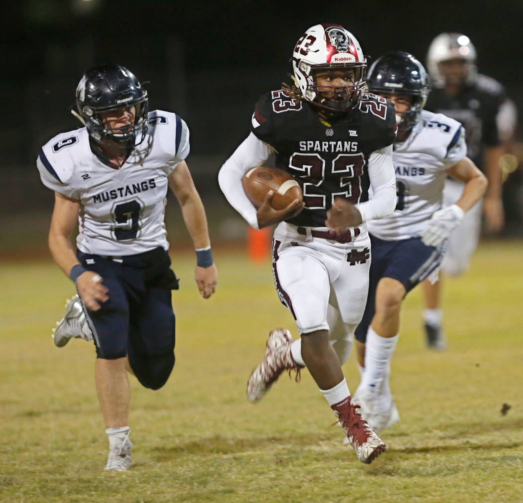 Cimarron-Memorial’s Jordan Norwood (23) carries a ball as Shadow Ridge’s Chase ...