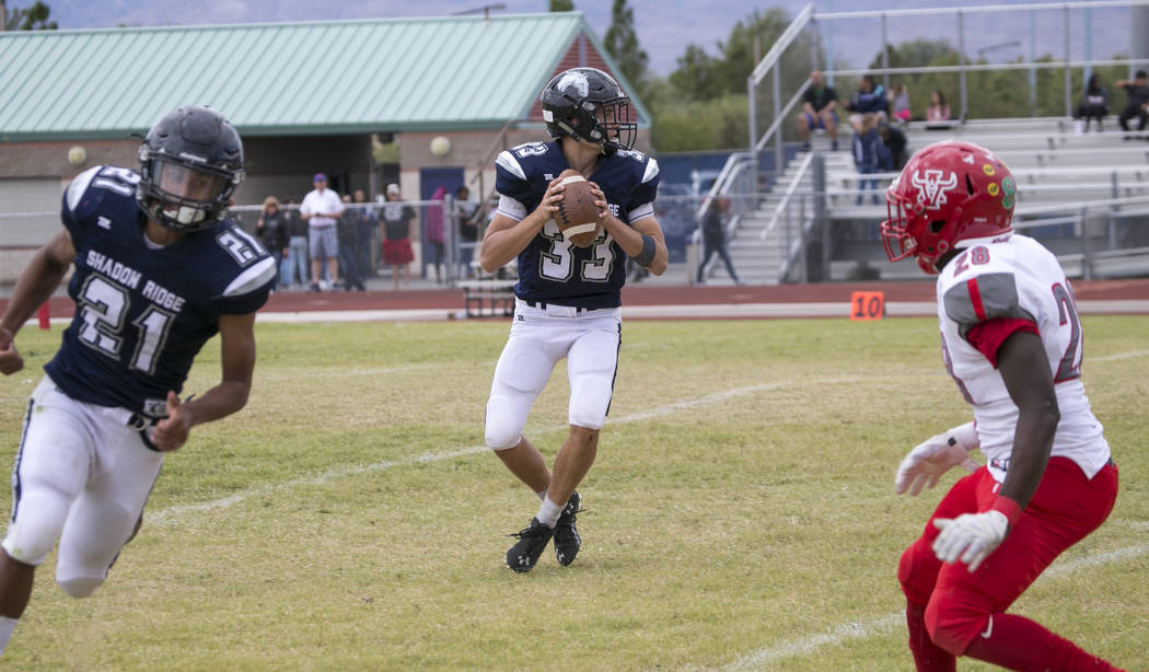 Shadow Ridge quarterback Kody Presser (33) looks for the open receiver against Arbor View du ...