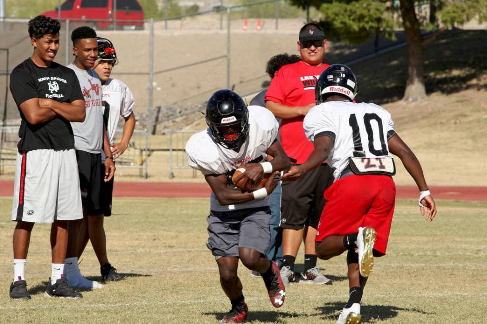 Running back Elijah Hicks (10) passes the ball to fellow Running back Cody Summer (25) durin ...