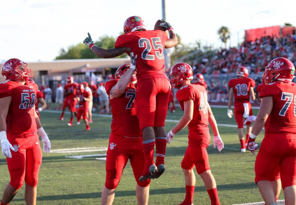 Arbor View Aggies running back Kyle Graham (25) celebrates with teammates after scoring a to ...