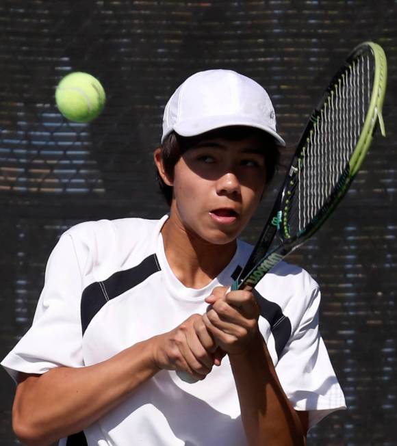 Clark High’s doubles player Dustin Mader returns the ball against Palo Verde High duri ...