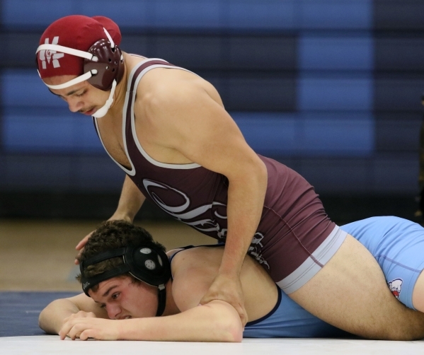 Cimarron-Memorial senior Nathaniel Garcia, top, wrestles Centennial sophomore Dayton Brown d ...