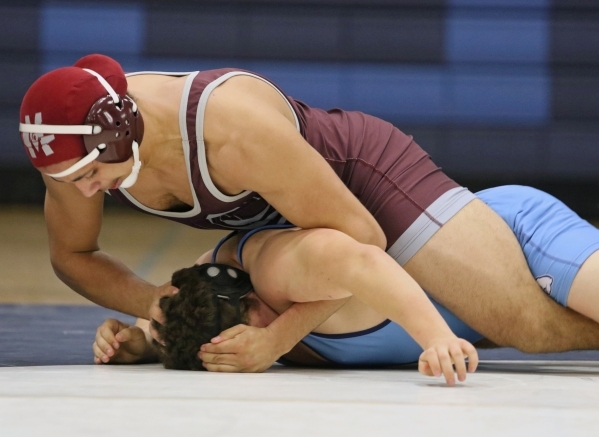 Cimarron-Memorial senior Nathaniel Garcia, top, wrestles Centennial sophomore Dayton Brown d ...