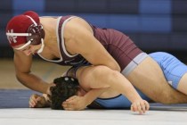 Cimarron-Memorial senior Nathaniel Garcia, top, wrestles Centennial sophomore Dayton Brown d ...