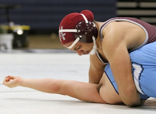 Cimarron-Memorial senior Nathaniel Garcia, top, wrestles Centennial sophomore Dayton Brown d ...