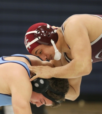 Cimarron-Memorial senior Nathaniel Garcia, right, wrestles Centennial sophomore Dayton Brown ...