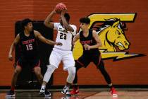 Liberty’s Cameron Burist (15) and teammate Liberty’s Terrance Marigney (13) guar ...