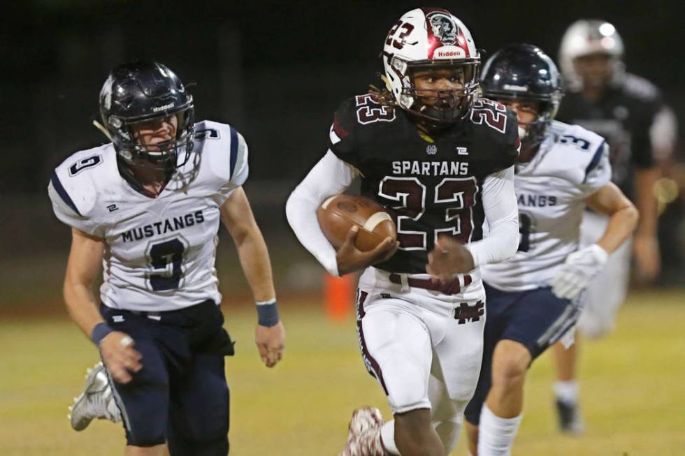 Cimarron-Memorial’s Jordan Norwood (23) carries a ball as Shadow Ridge’s Chase ...