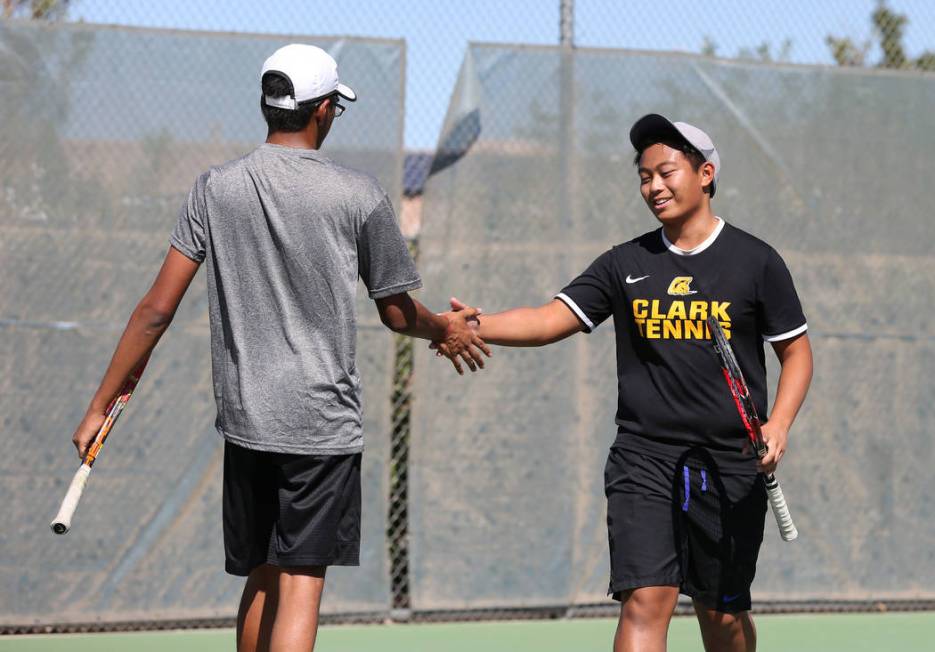 Clark’s High double players Simran Shah, left, and Mark Bernales shake hands after win ...