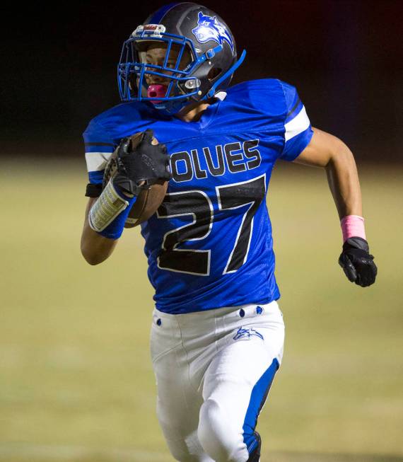 Basic wide receiver Michael Click (27) runs for a touchdown against Foothill defenders durin ...