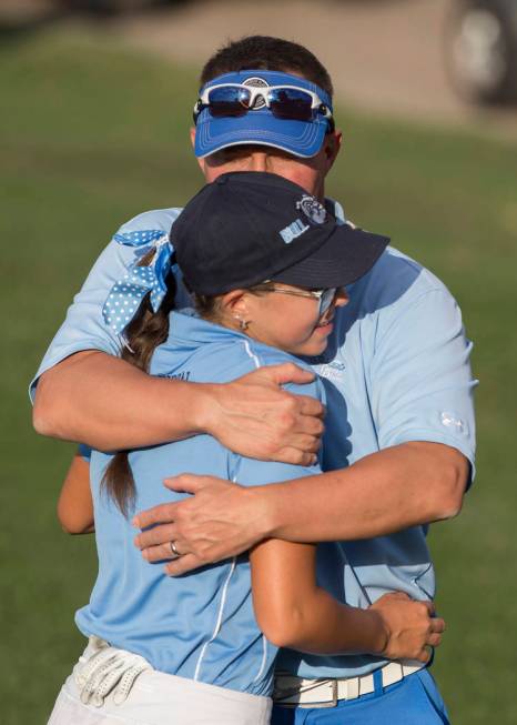 Centennial sophomore McKenzi Hall gets a hug from her dad Ken Hall after winning the region ...