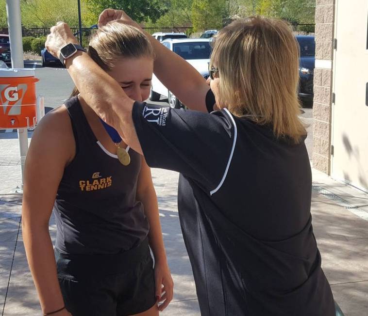 Assistant tournament director Pat Davis, right, awards Clark’s Audrey Boch-Collins the ...