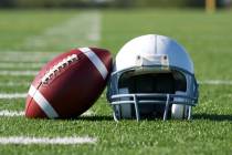 American Football and Helmet on the Field