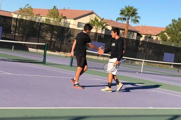 Clark’s Artem Iermolov and Mathew Spagnolo celebrate a point during a doubles match ag ...