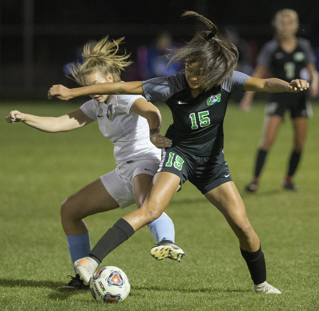 Green Valley junior forward Jazlyn Camacho (15) fights for a loose ball with Foothill senior ...