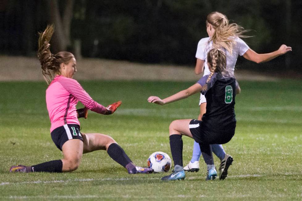 Green Valley junior goal keeper Nicolette De La Carrera (11) and teammate Ali Morton (8) def ...