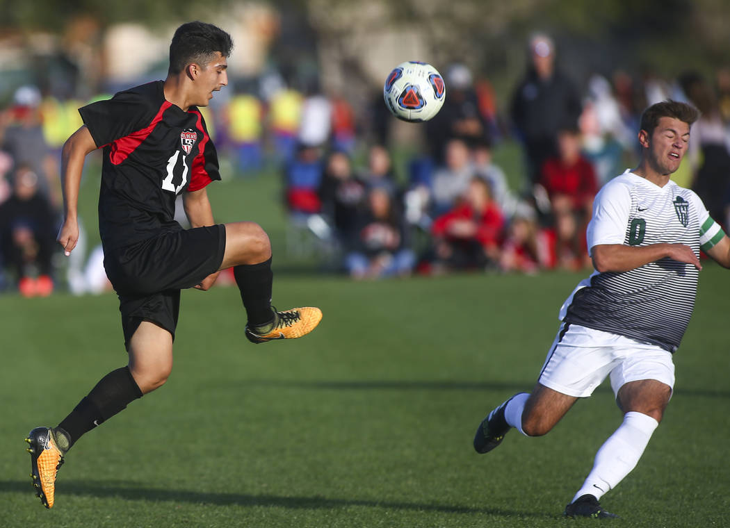 Las Vegas’ Rigo Carrasco (11) kicks the ball past Palo Verde’s Anthony Kaskie (1 ...