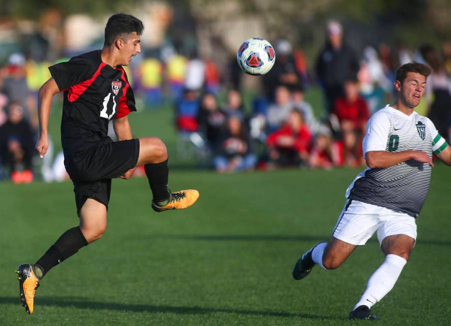 Las Vegas’ Rigo Carrasco (11) kicks the ball past Palo Verde’s Anthony Kaskie (1 ...