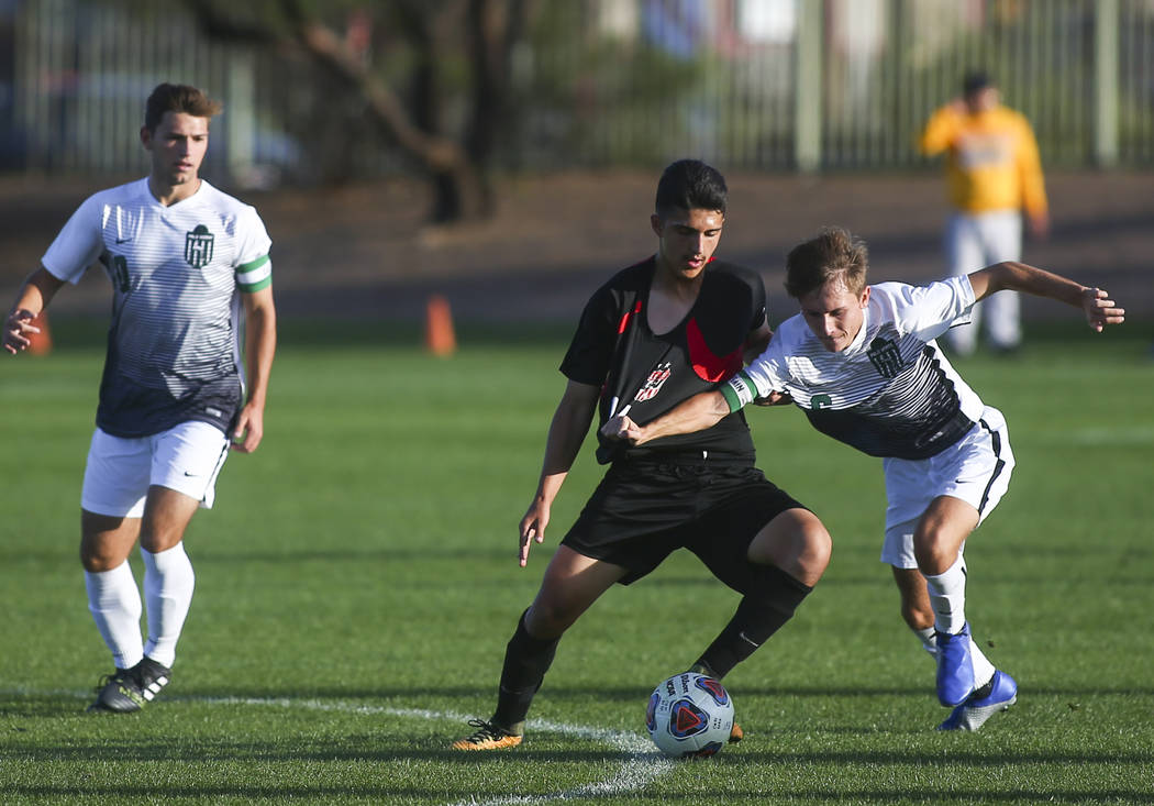 Las Vegas’ Rigo Carrasco (11) battles for the ball against Palo Verde’s Tanner S ...