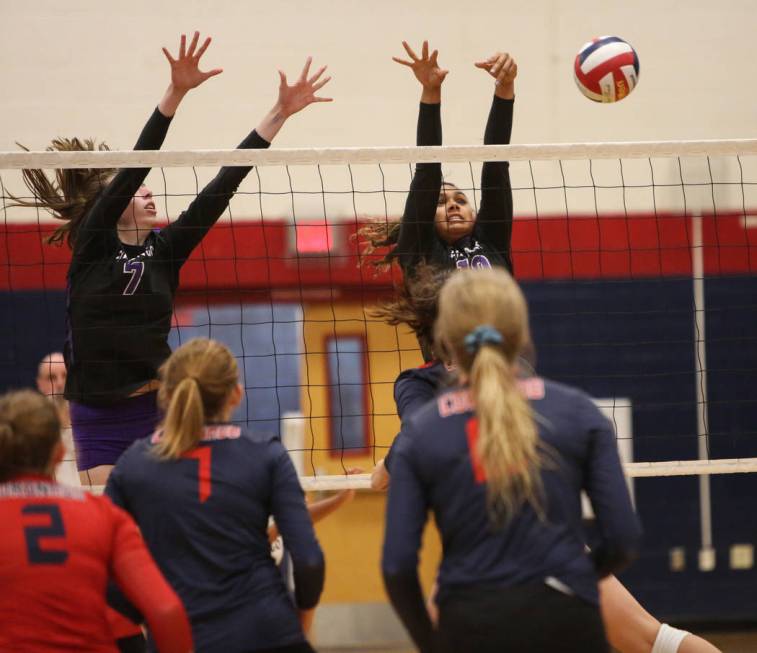 Durango’s Lindsay McMahon, left, and Tatiana Johnson attempt to block the ball during ...