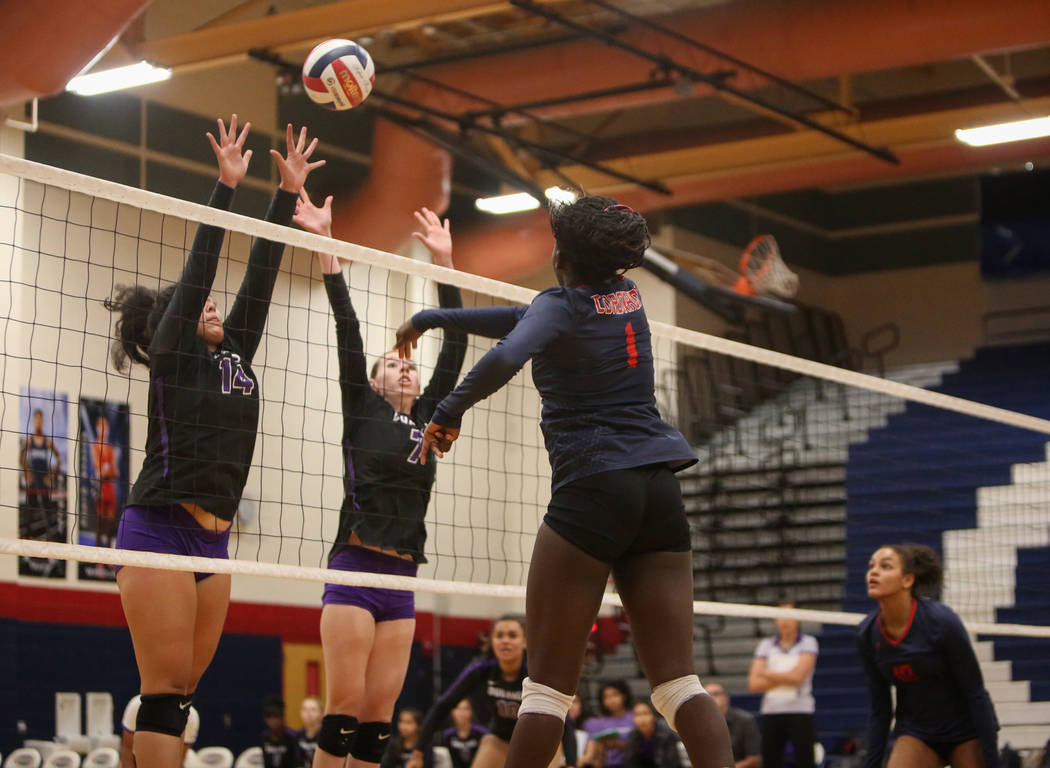 Coronado’s Morenike Ajayi hits the ball over the net as Durango’s Tehani Faitau, ...