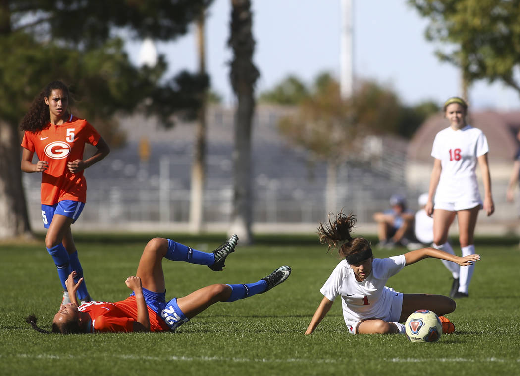 Bishop Gorman’s Kennedy Enus (22) gets tripped up next to Coronado’s Rachel Burt ...