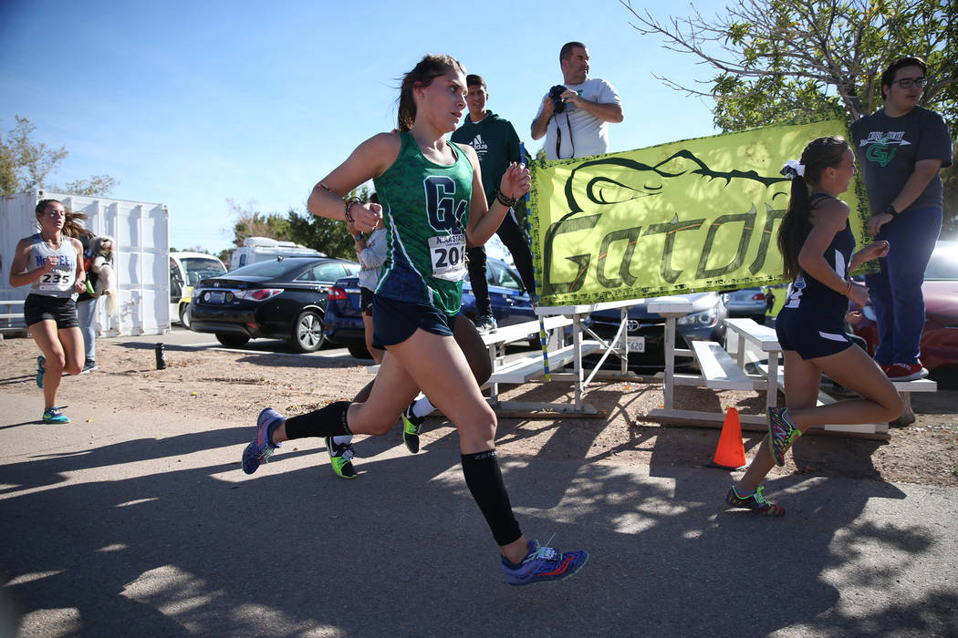 Green Valley’s Mia Smith, 17, center, competes in the NIAA 4A Girls Cross Country Stat ...