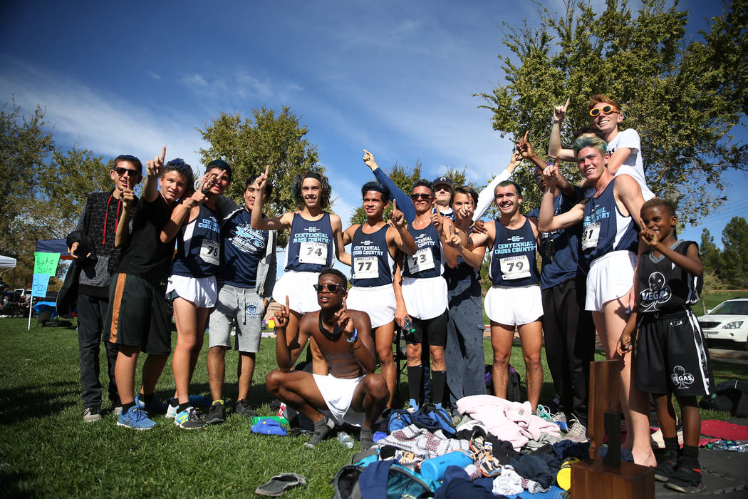 Centennial boys runners pose for photos after the NIAA 4A Boys Cross Country State Champions ...